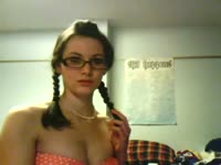 Pigtailed webcam newcomer in nerdy glasses looks seductive while modeling her flawless body